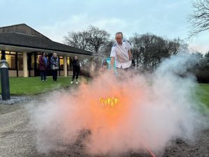 Delegate completing practical fire extinguisher training with Essential 6